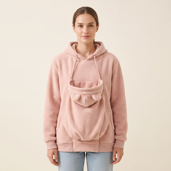 Studio shot of the Cozy Carry fleece hoodie in pink showing the empty carrier pouch